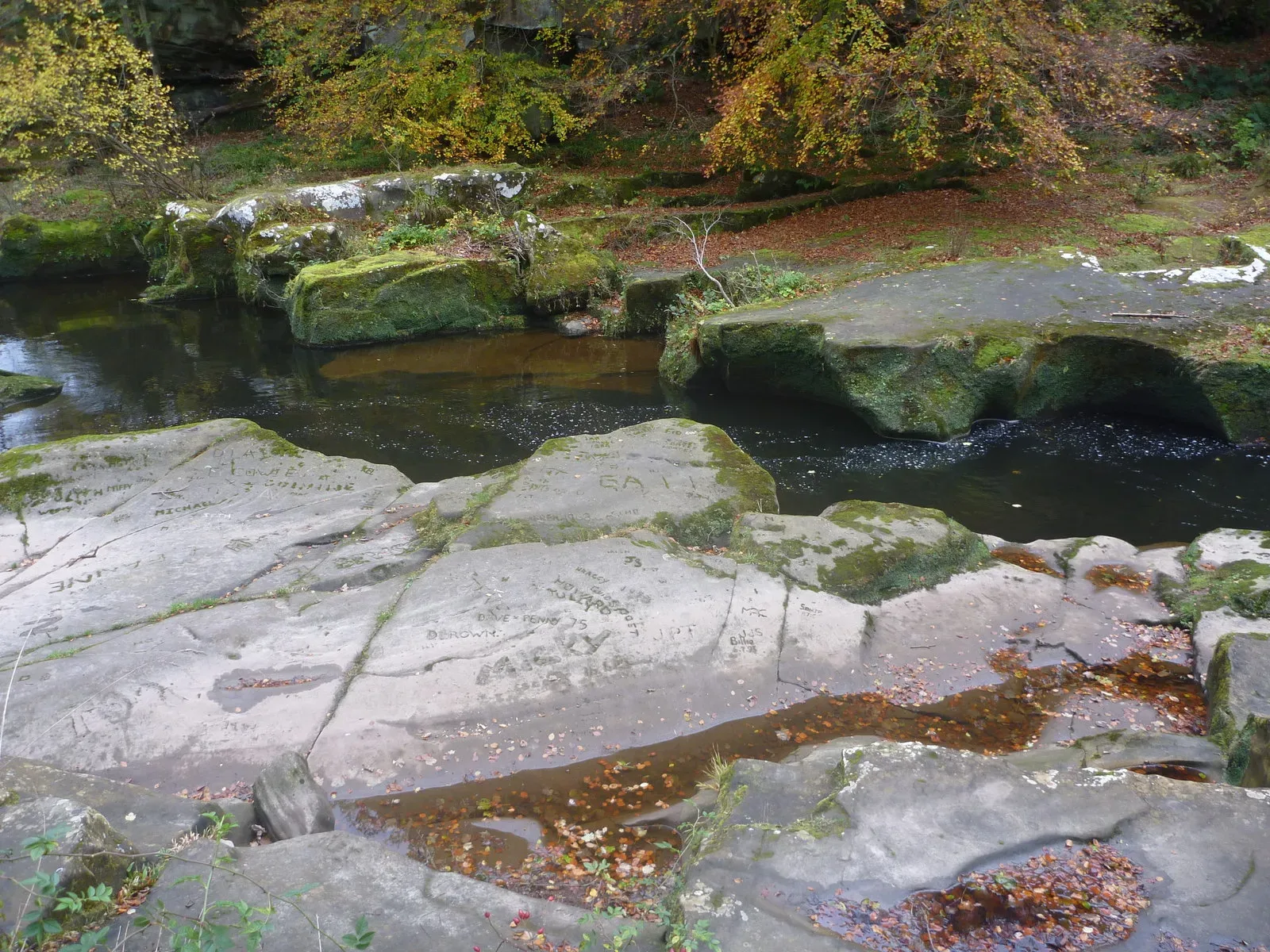 Carved rocks and a river near Thrum Mill, Rothbury, in Northumberland
