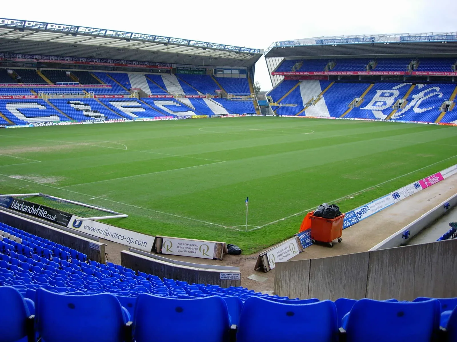Inside St Andrew's stadium, with blue seats around the pitch
