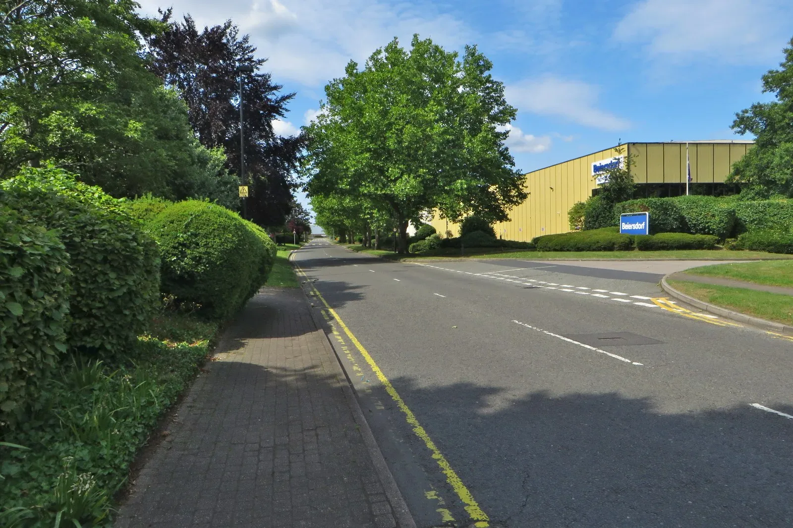 Industrial units and a tree-lined road on an estate in Birmingham