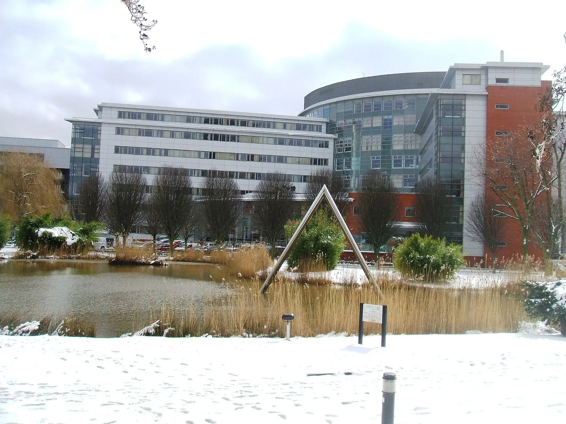 The lake and buildings of Aston University's campus
