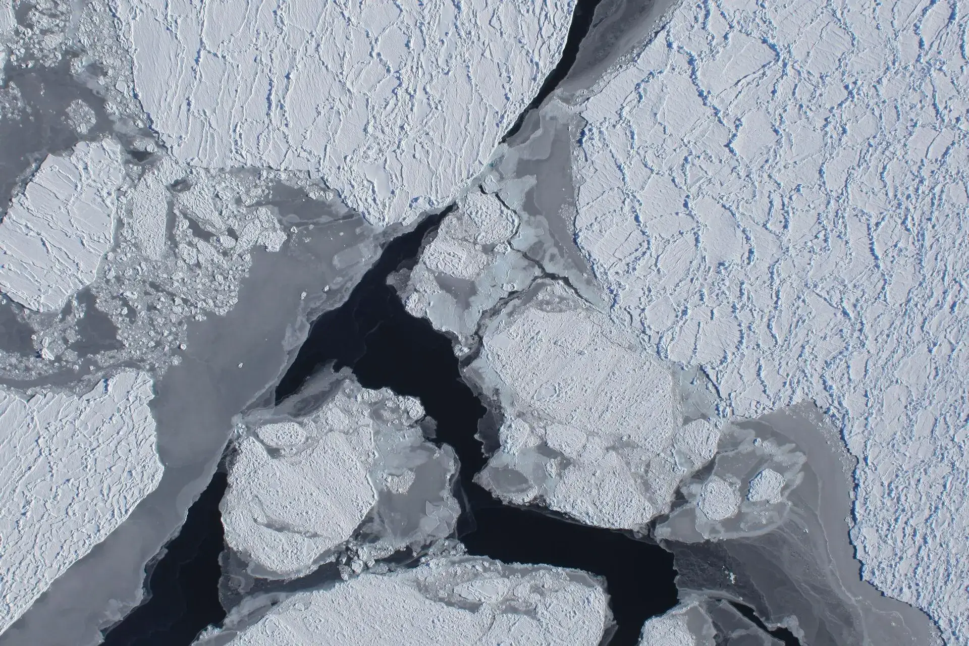 Aerial view of broken sea ice and dark open water in the Antarctic