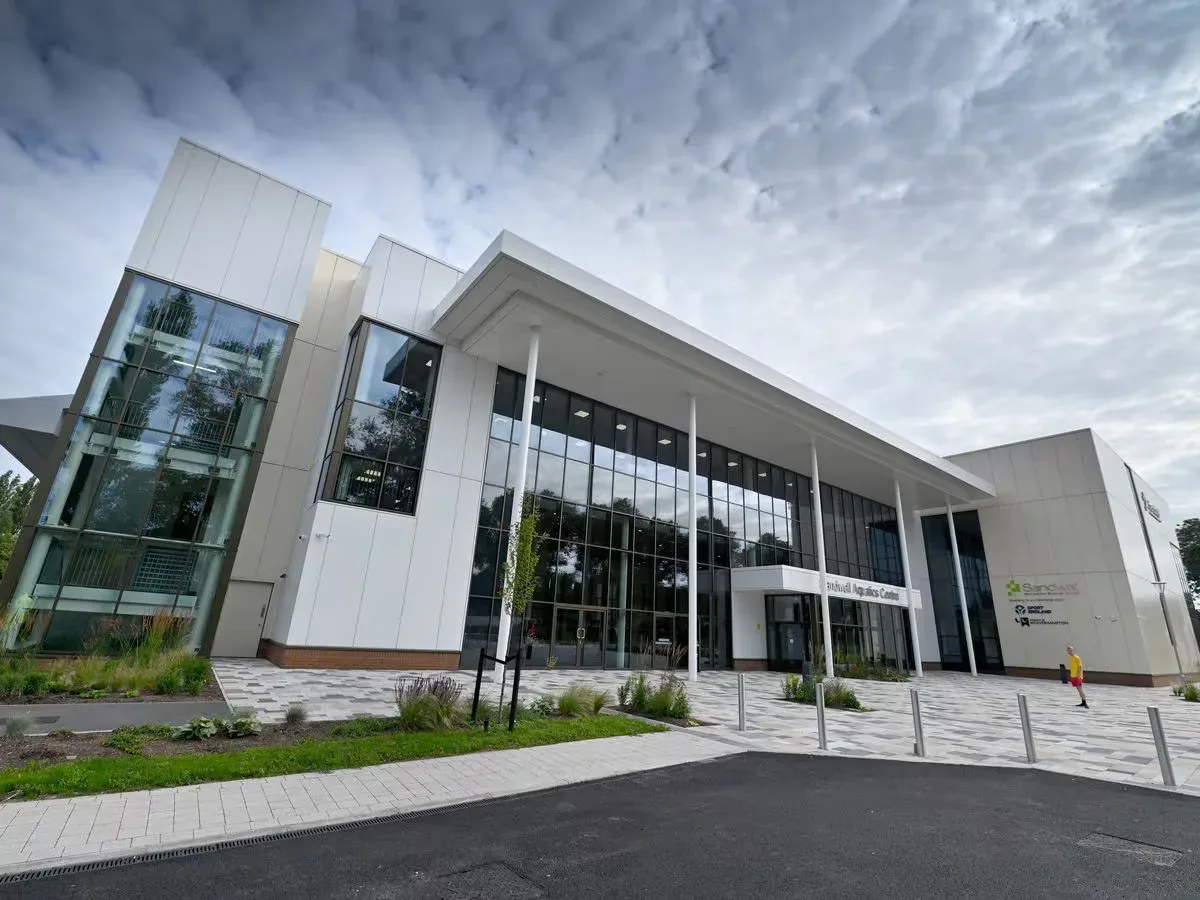 The Sandwell Aquatics Centre, a white building with tall glass windows