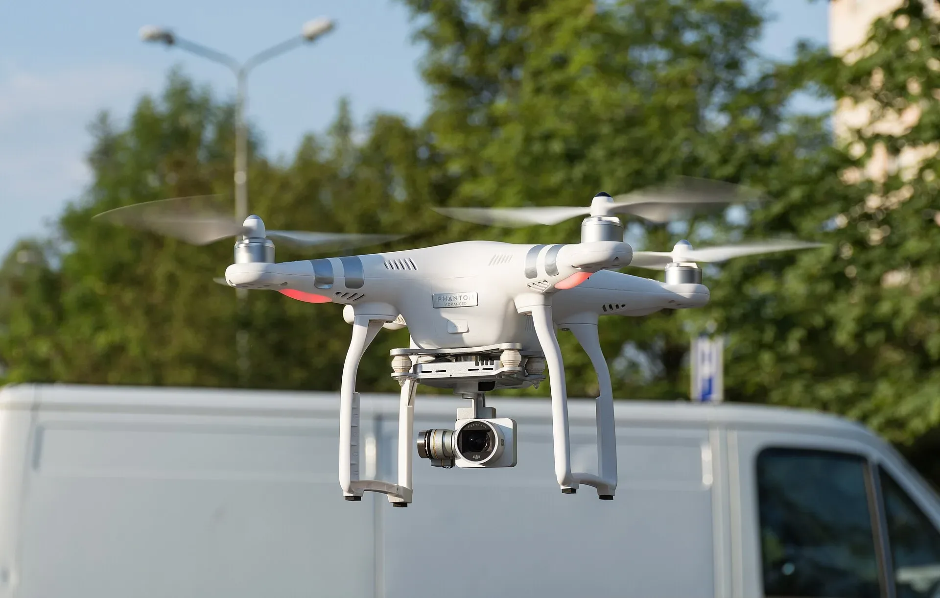 A small white quadcopter drone in flight