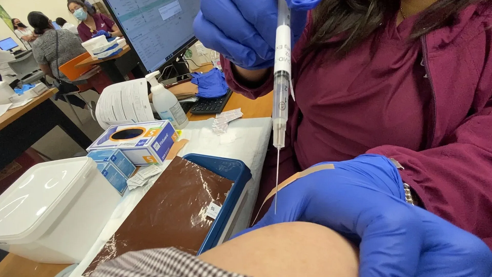 A vaccine being injected into a person's upper arm