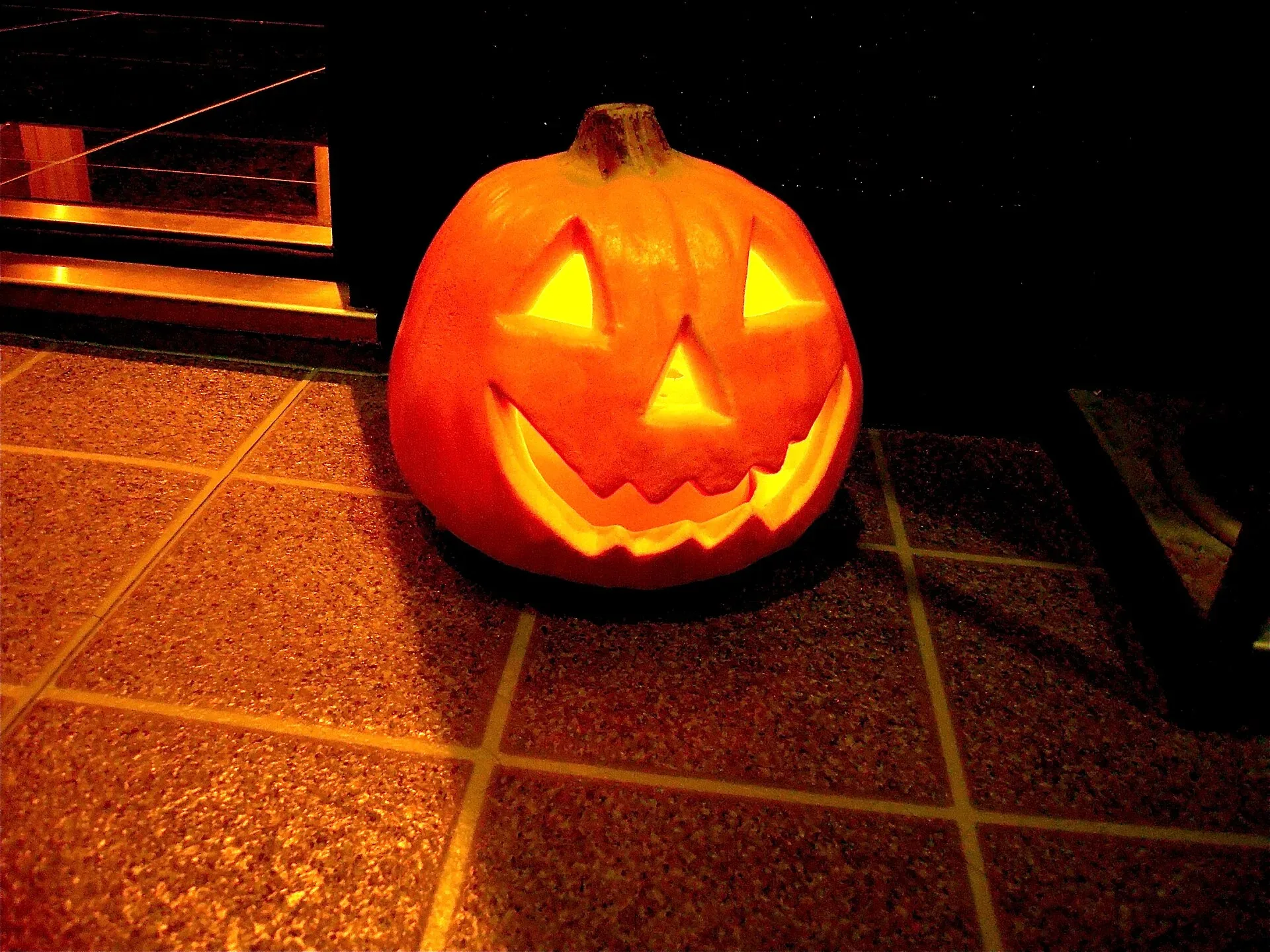 A glowing carved pumpkin lantern