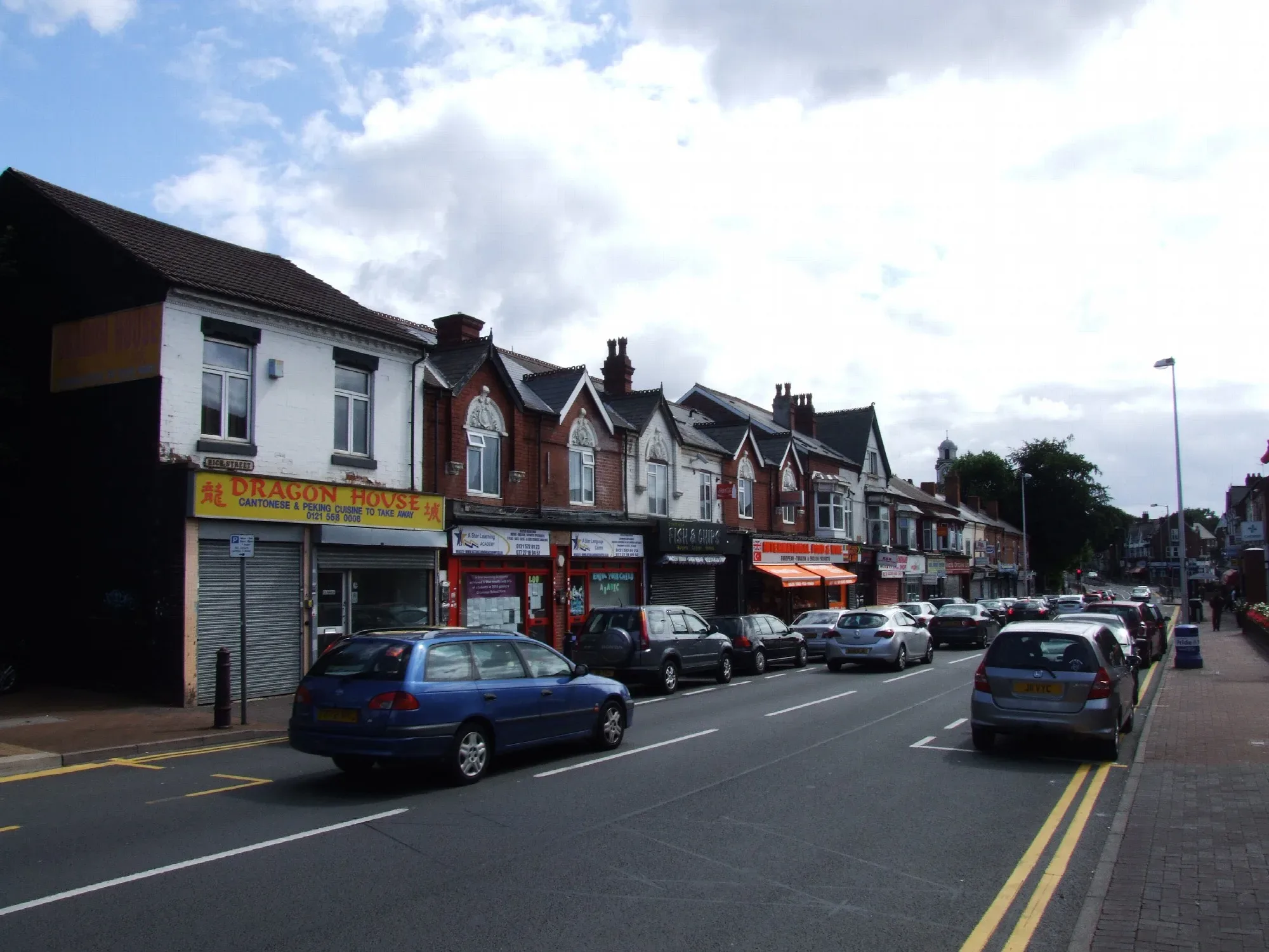 Shops along High Street, Smethwick, on a cloudy day