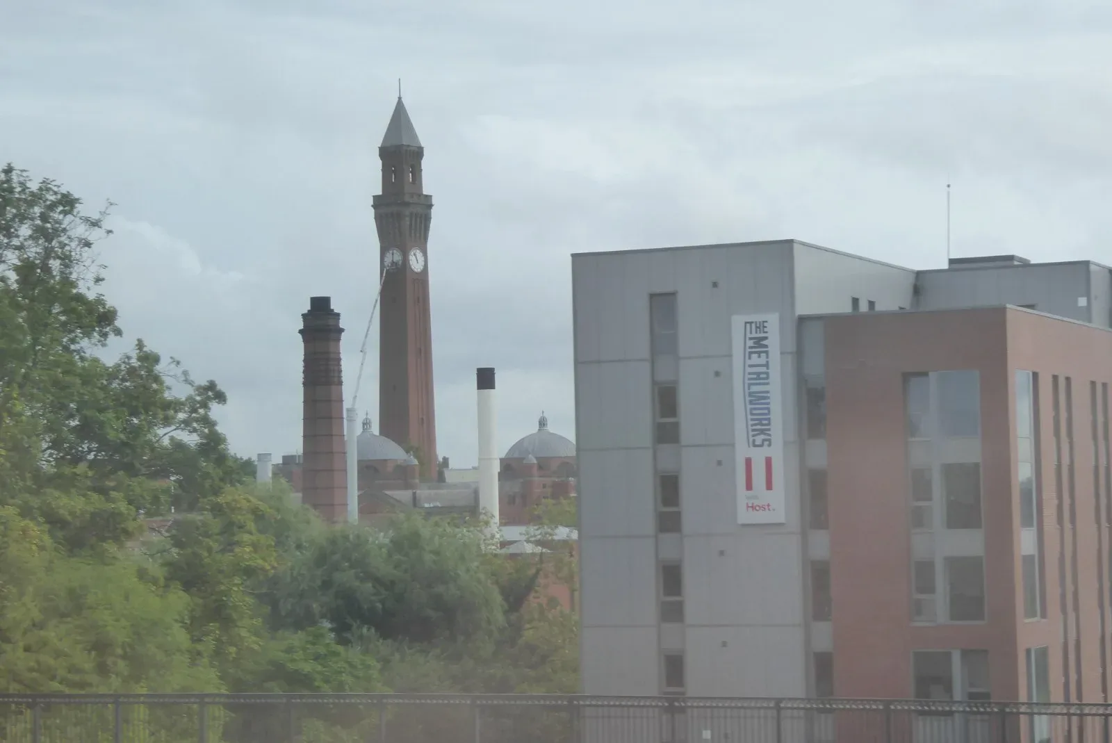 The Chamberlain Clock Tower at the University of Birmingham rising above trees