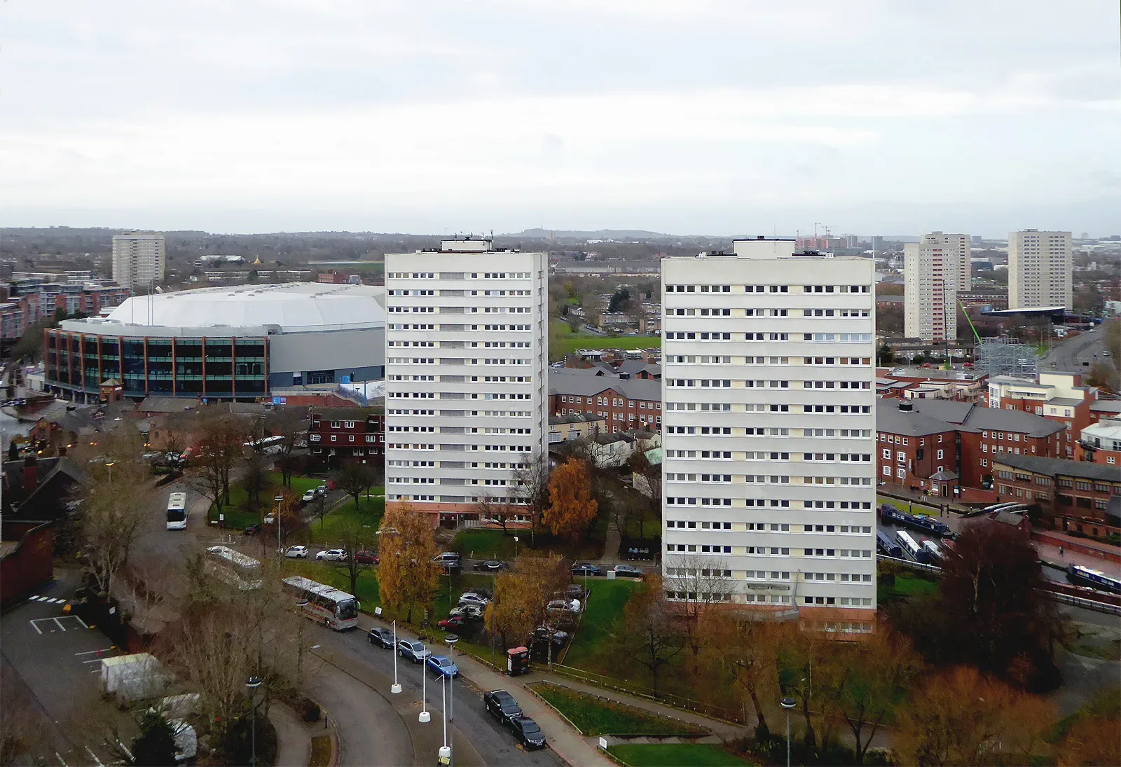 Two white residential tower blocks among buildings in Birmingham