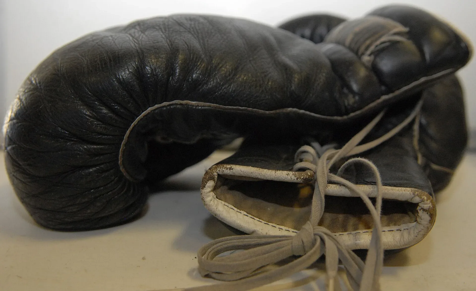A pair of black leather boxing gloves